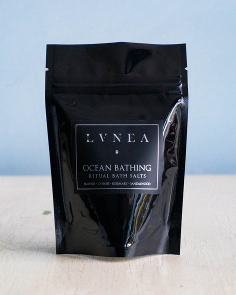 Small black bag containing coarse sea salt bath salts by Lvnea.