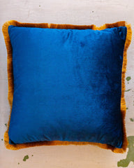 square blue velvet throw pillow with gold fringe