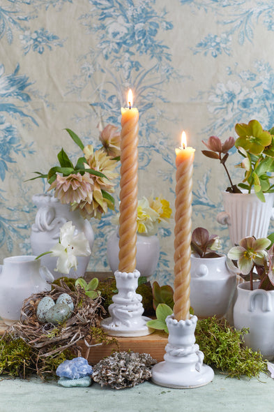 White ceramic candle holders with candles