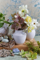 White ceramic bud vase with flowers