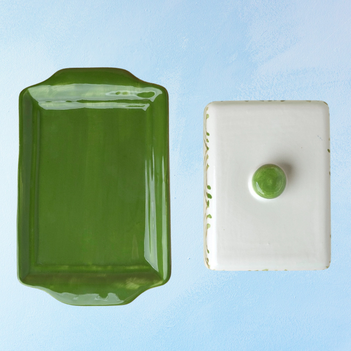 ceramic butter dish with a green bottom base and white lid with green accents