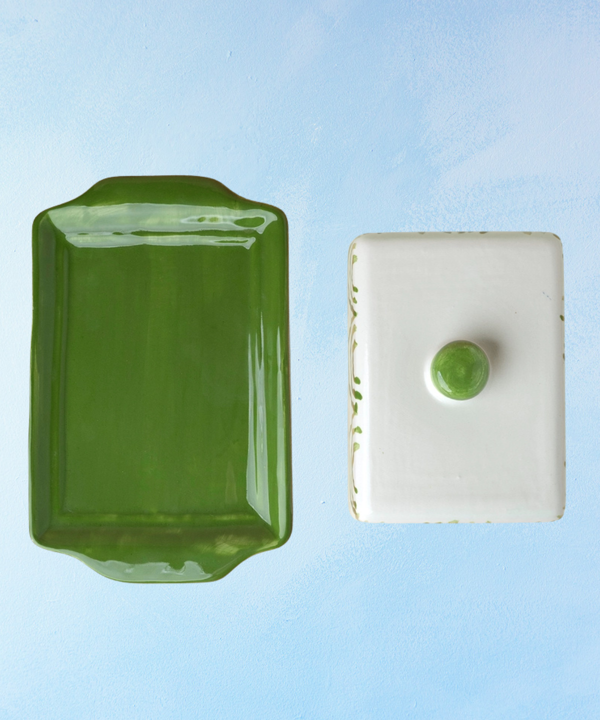 ceramic butter dish with a green bottom base and white lid with green accents