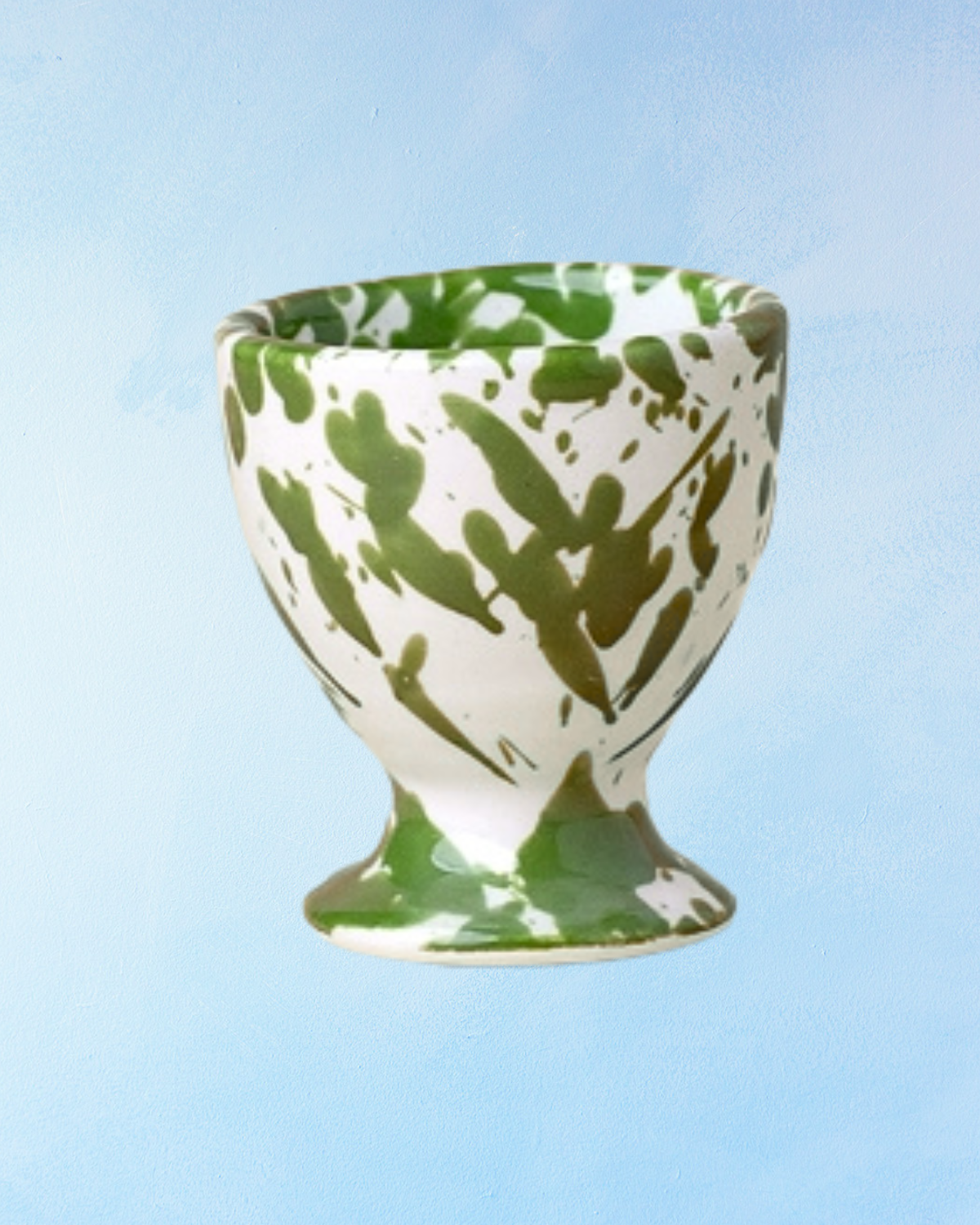 ceramic egg cup with white base and moss toned green splatter design