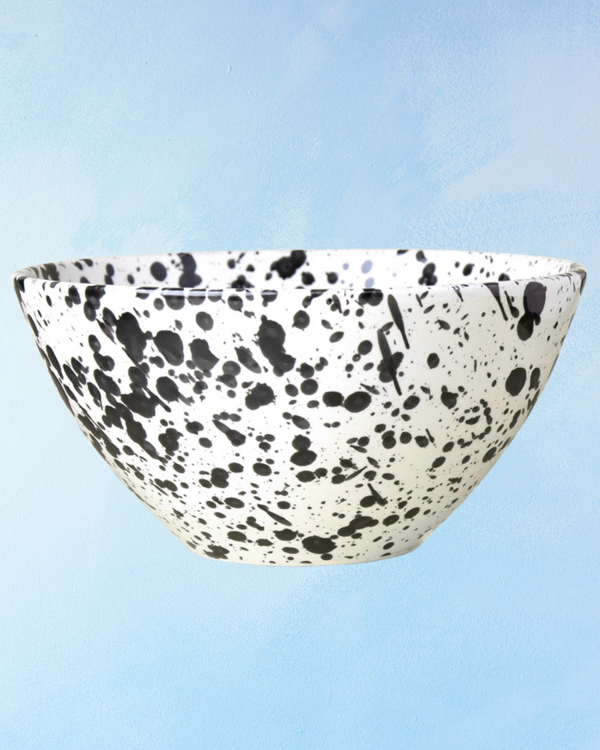 ceramic salad bowl with a white base and black splatter design