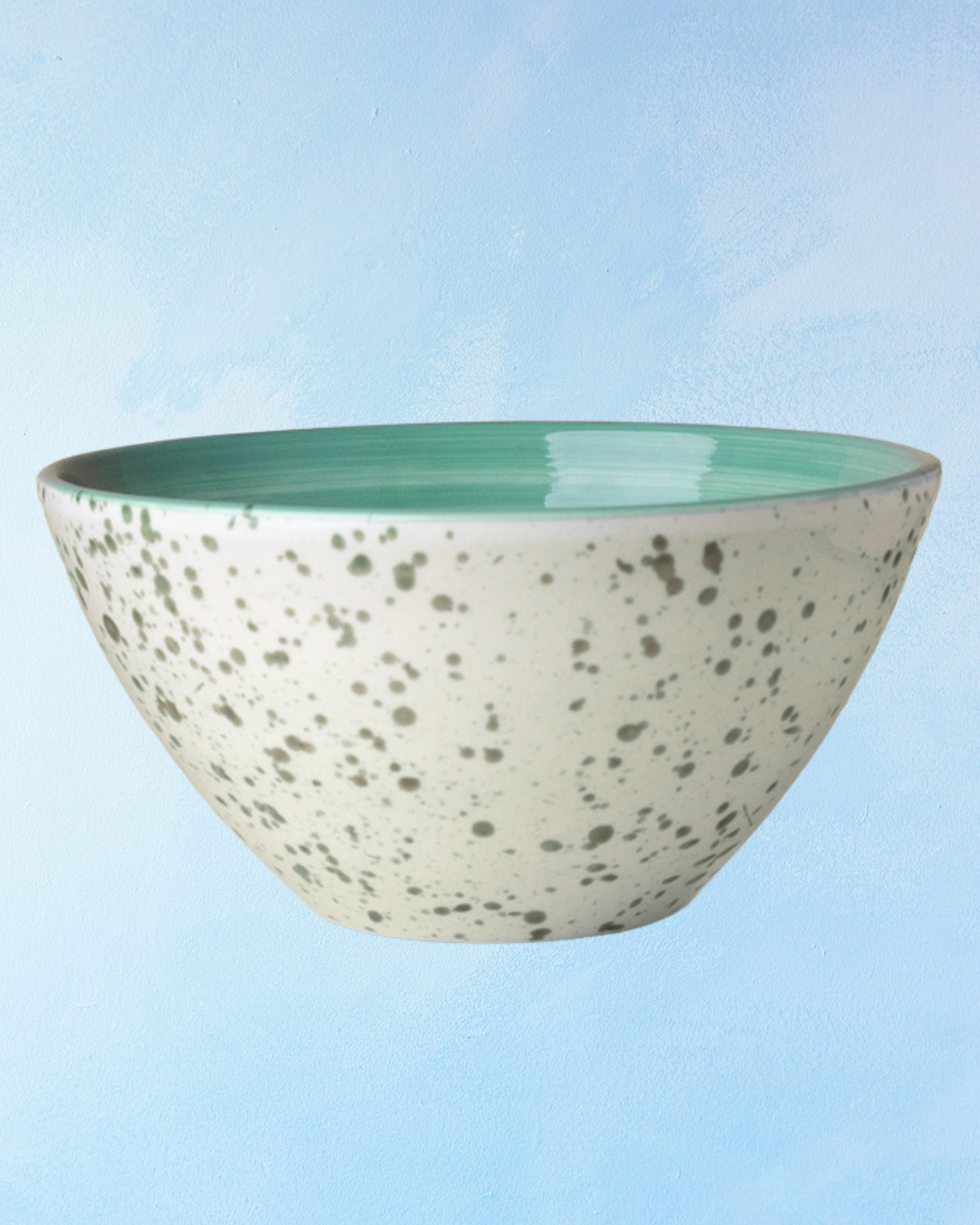 ceramic salad bowl with a white base, green interior, and green speckle design
