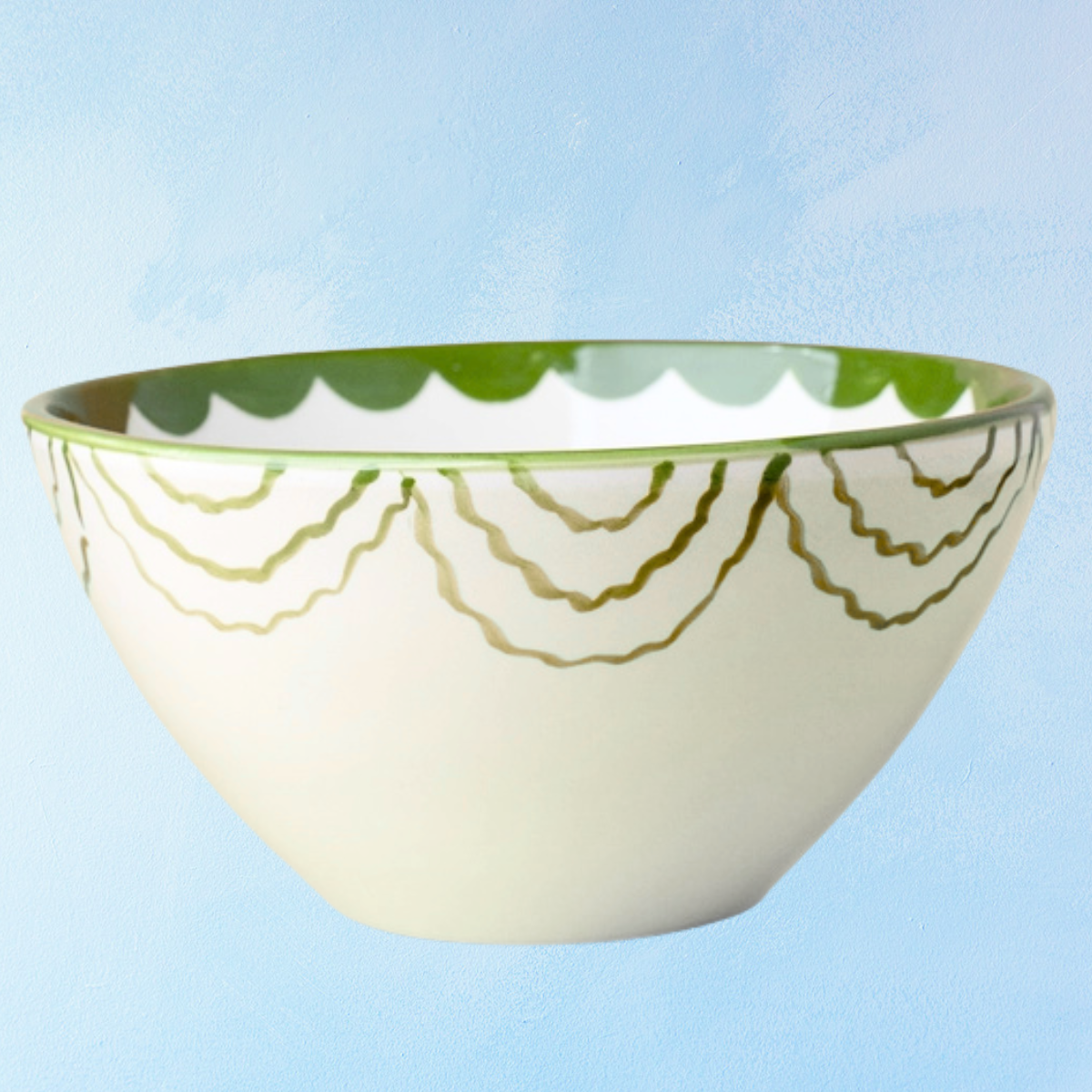 ceramic salad bowl with white base, white interior, green interior bottom, green scalloped trim on exterior and interior