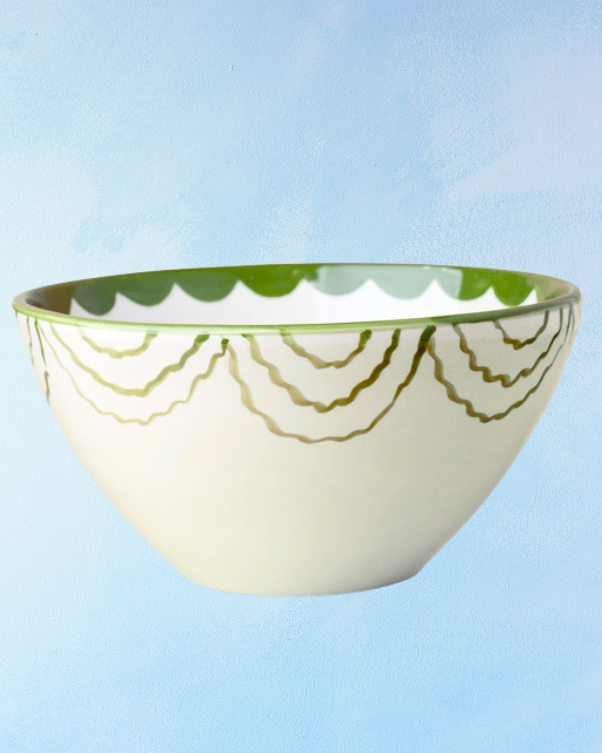 ceramic salad bowl with white base, white interior, green interior bottom, green scalloped trim on exterior and interior