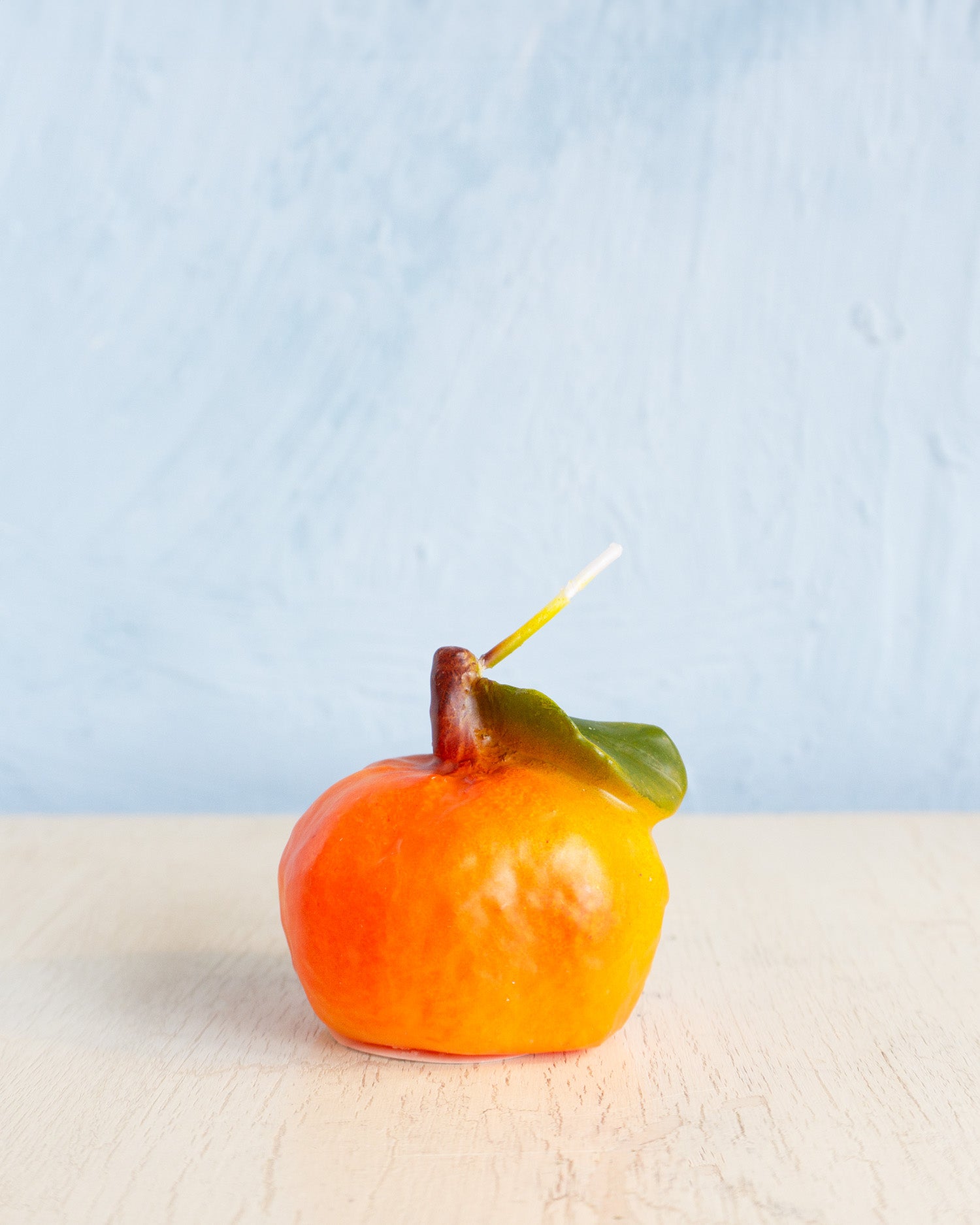 candle - food: clementine with leaf
