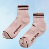 Pair of pink socks with brown stripes and 'LEBON SHOPPE' branding on a light blue background