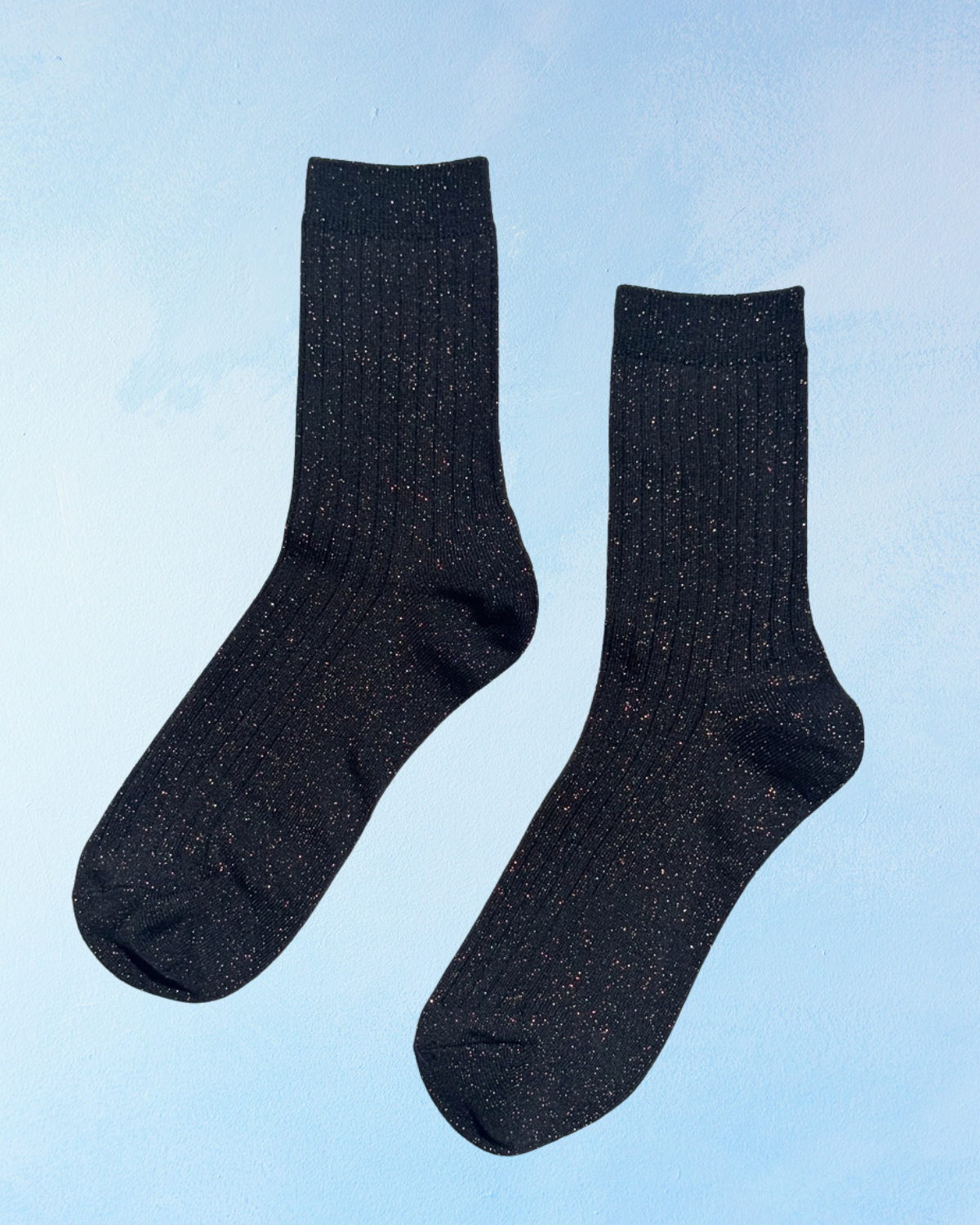 Sparkly black ribbed socks on a bluebackground