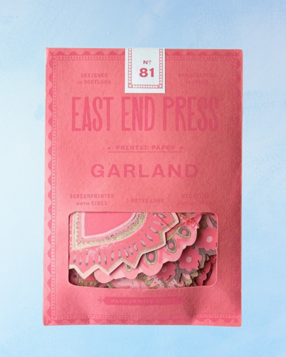 Pink packaging of 'Garland' by East End Press on a light blue background