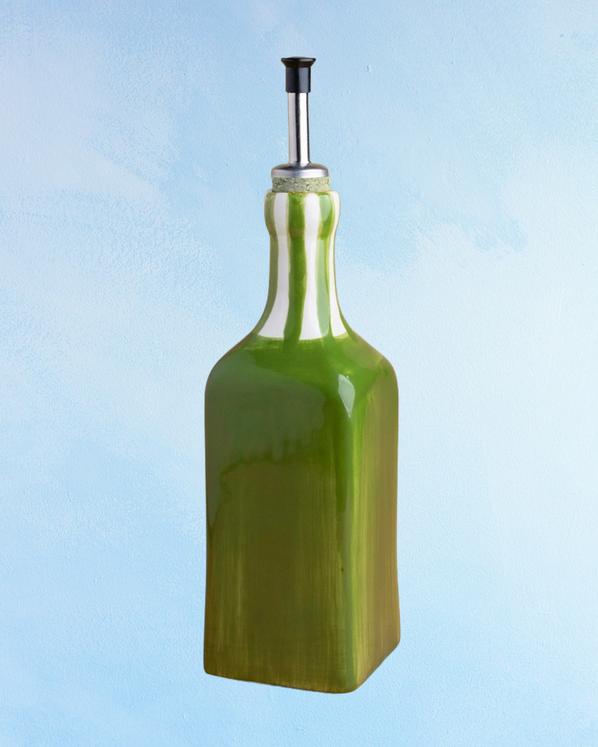 ceramic oil dispenser with square shape, green base and green and white striped spout. There is a cork stopper with stainless steel spout inside.