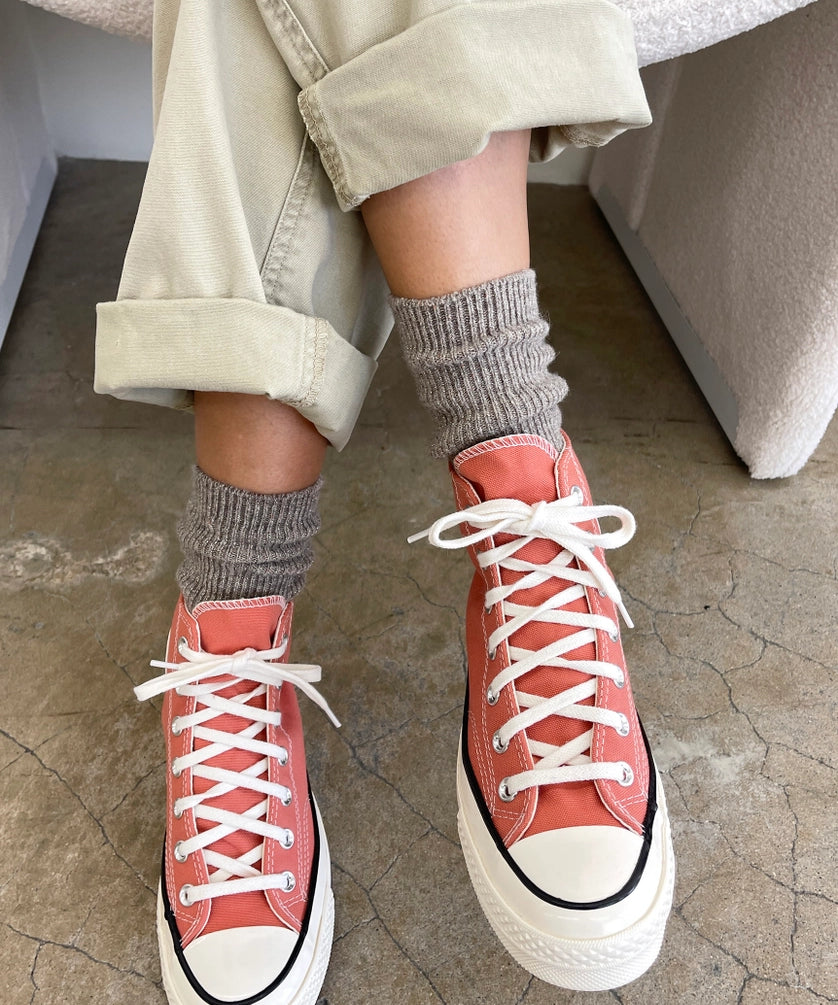 Person wearing coral high-top sneakers and Le Bon Shoppe Winter Glitter socks in Ash