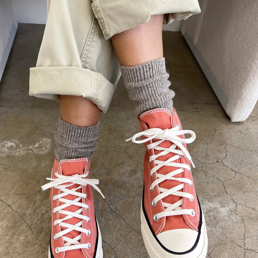 Person wearing coral high-top sneakers and Le Bon Shoppe Winter Glitter socks in Ash