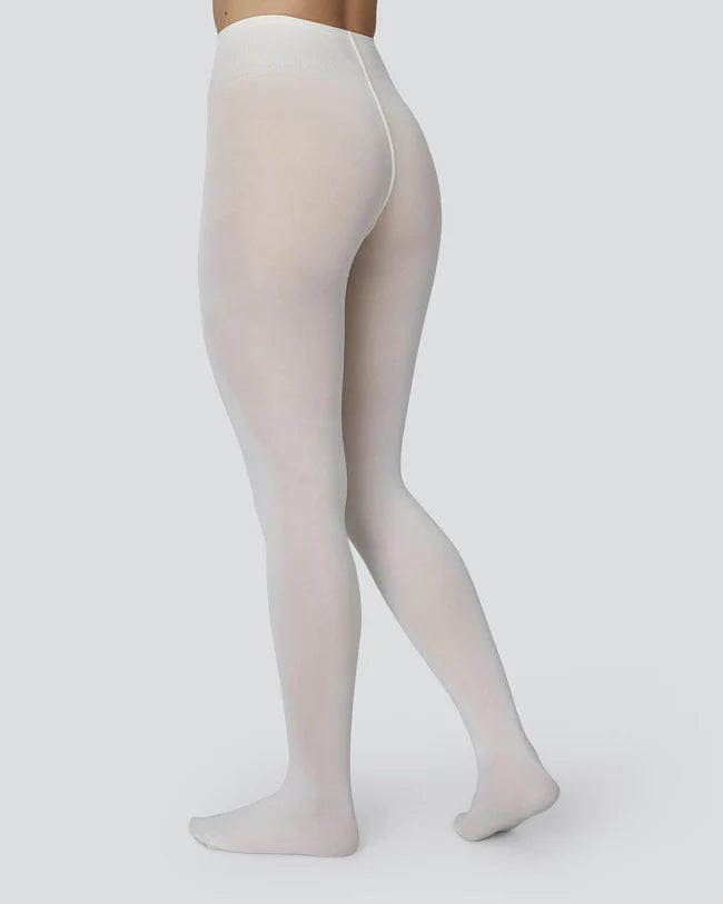 A model wearing Svea's Olivia ivory tights
