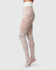 A model wearing Svea's Maja Flower tights in ivory