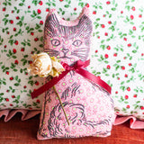 Calico cat balsam pillow in pink with a red ribbon