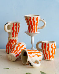 Six ceramic hand made mug with wavy orange stripes