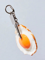 Realistic-looking fried egg keychain.