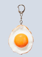 Realistic-looking fried egg keychain.