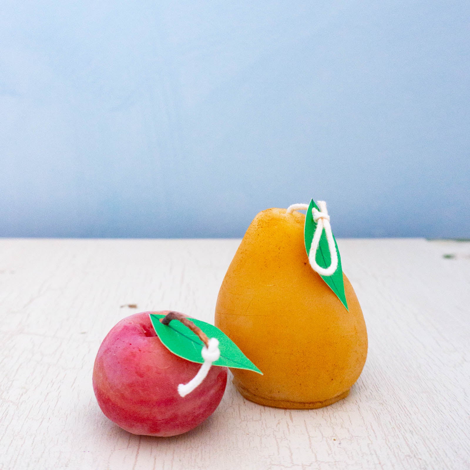 Beeswax candles shaped like an apple and a pear