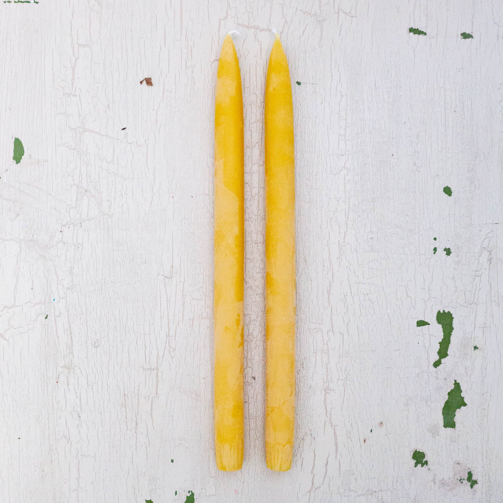 two bright yellow beeswax taper candles by Huckleberry Hives.