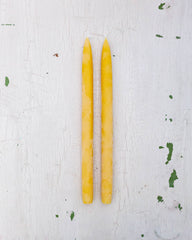 two bright yellow beeswax taper candles by Huckleberry Hives.