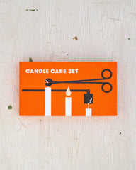 A candle care kit in the box