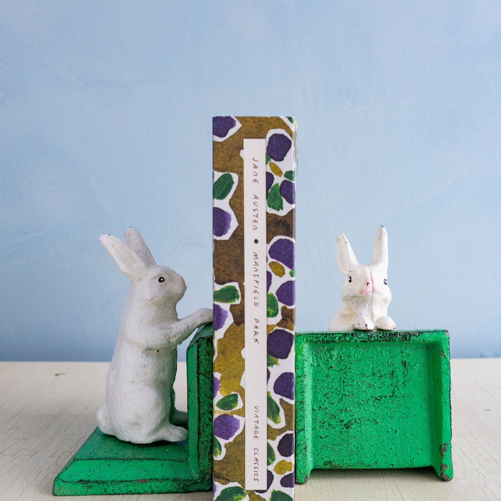Little cast iron bunny bookends holding up Jane Austen's Mansfield Park
