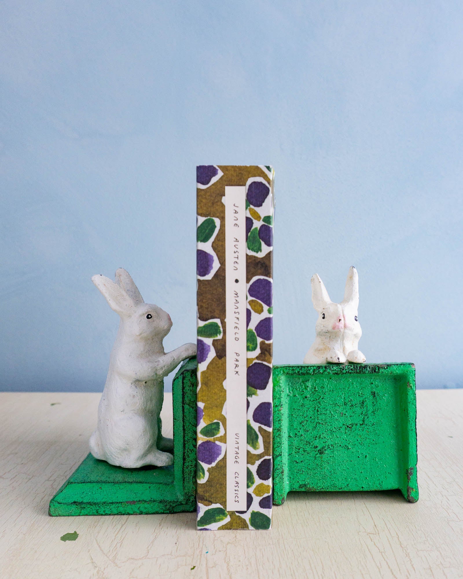 Little cast iron bunny bookends holding up Jane Austen's Mansfield Park