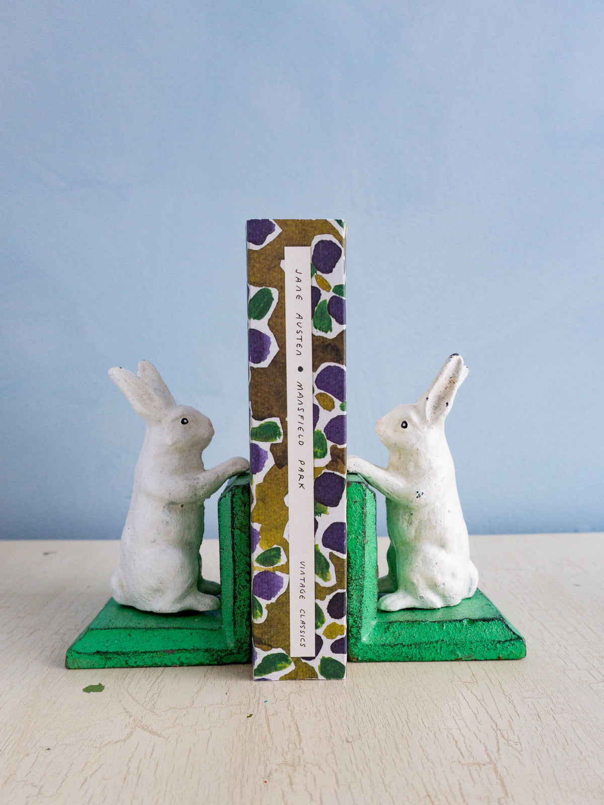 Little cast iron bunny bookends holding up Jane Austen's Mansfield Park