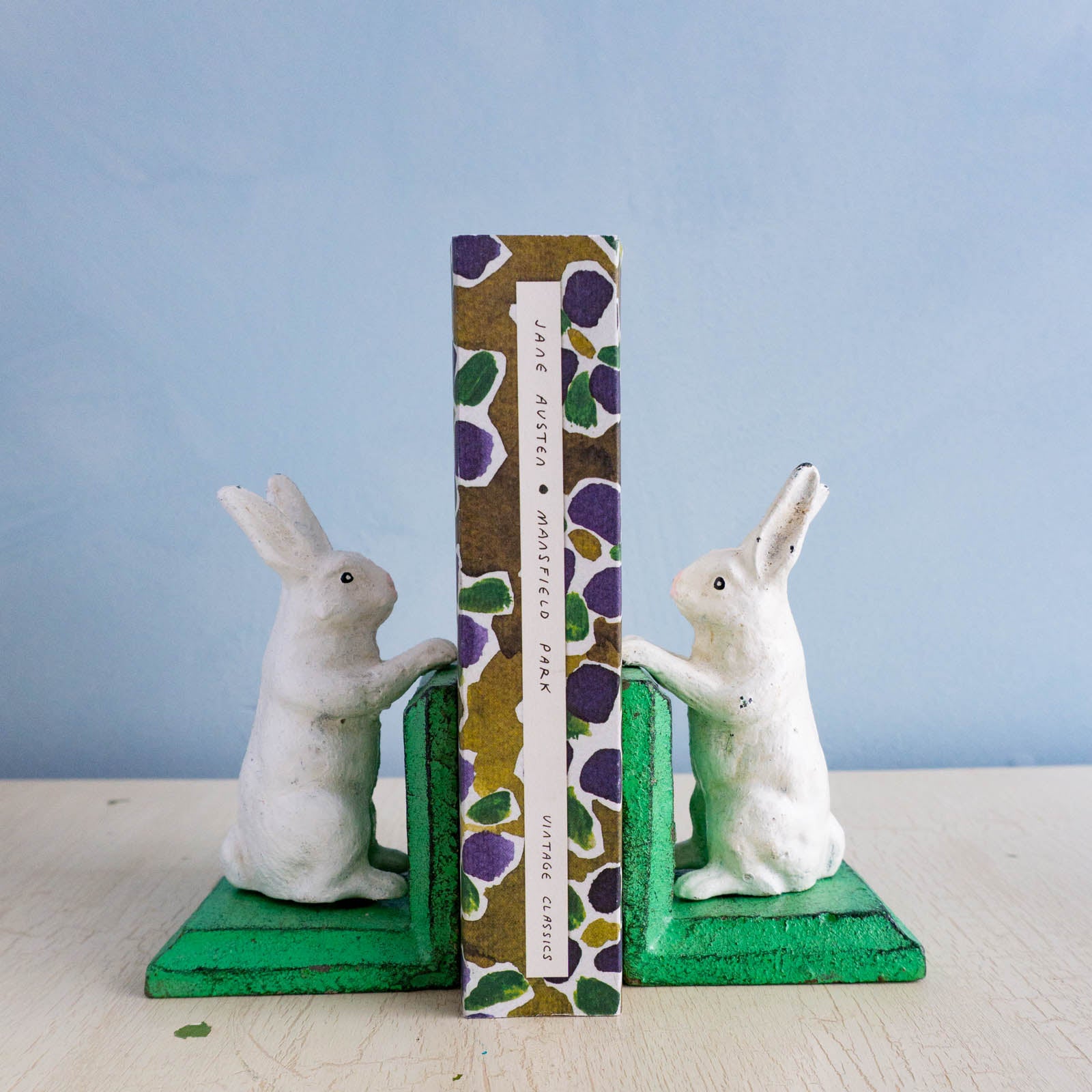 Little cast iron bunny bookends holding up Jane Austen's Mansfield Park