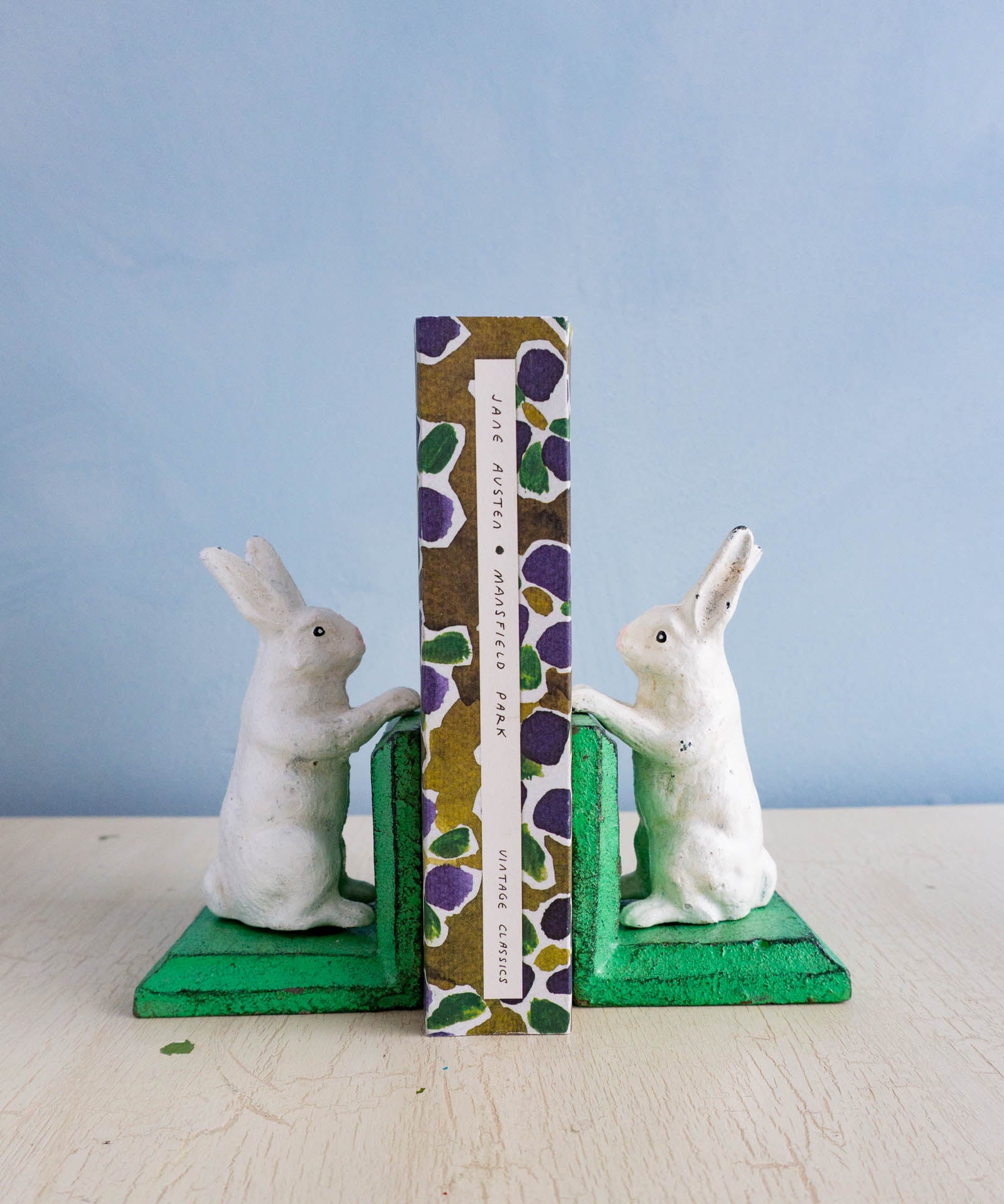 Little cast iron bunny bookends holding up Jane Austen's Mansfield Park