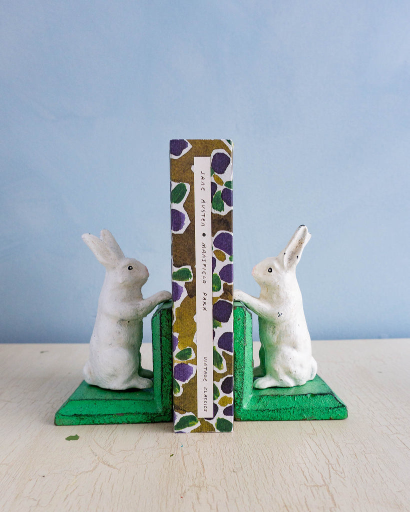 Little cast iron bunny bookends holding up Jane Austen's Mansfield Park