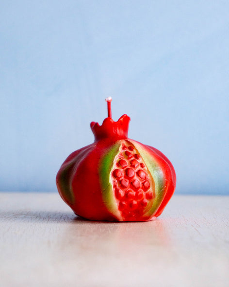 A candle shaped like a pomegranate