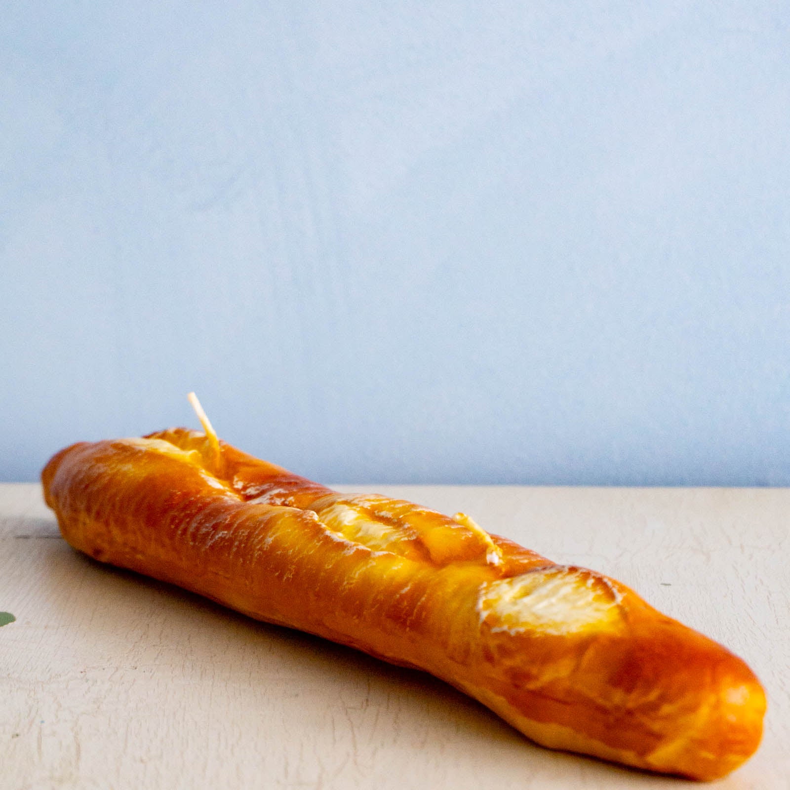 a candle shaped like a baguette 