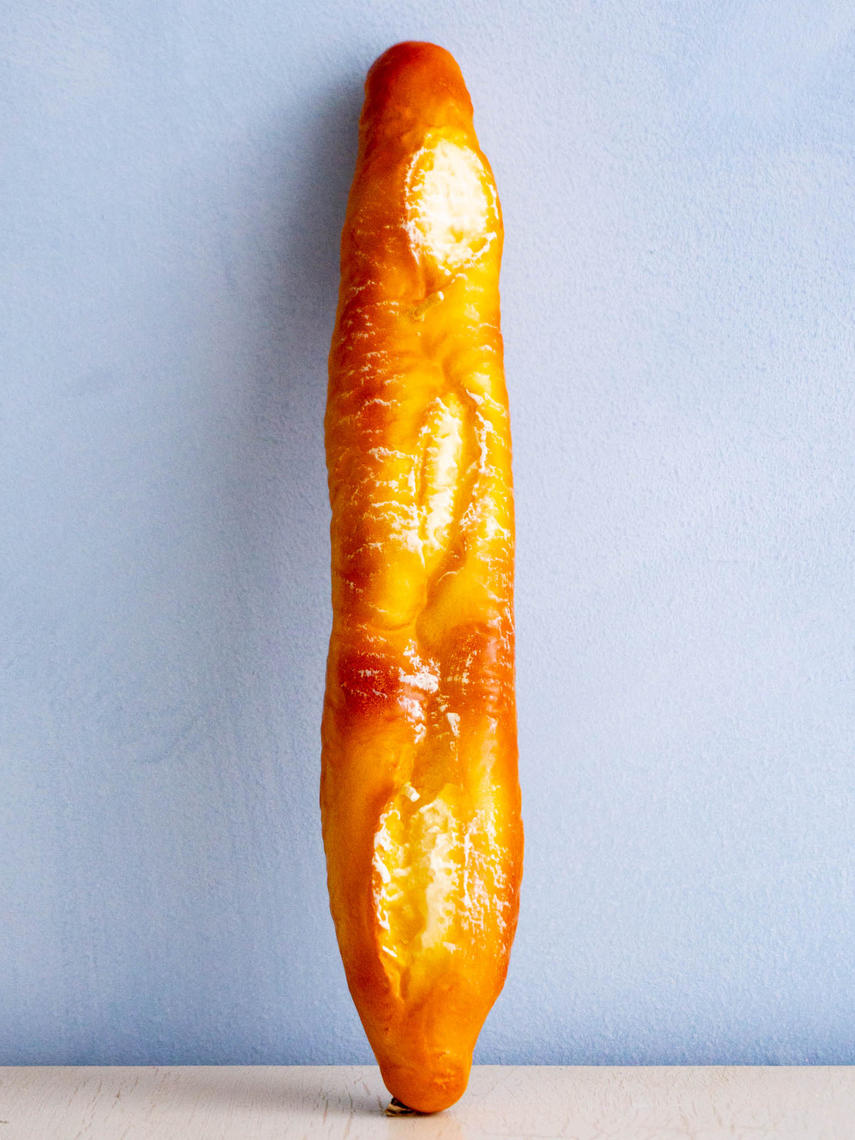 a candle shaped like a baguette 
