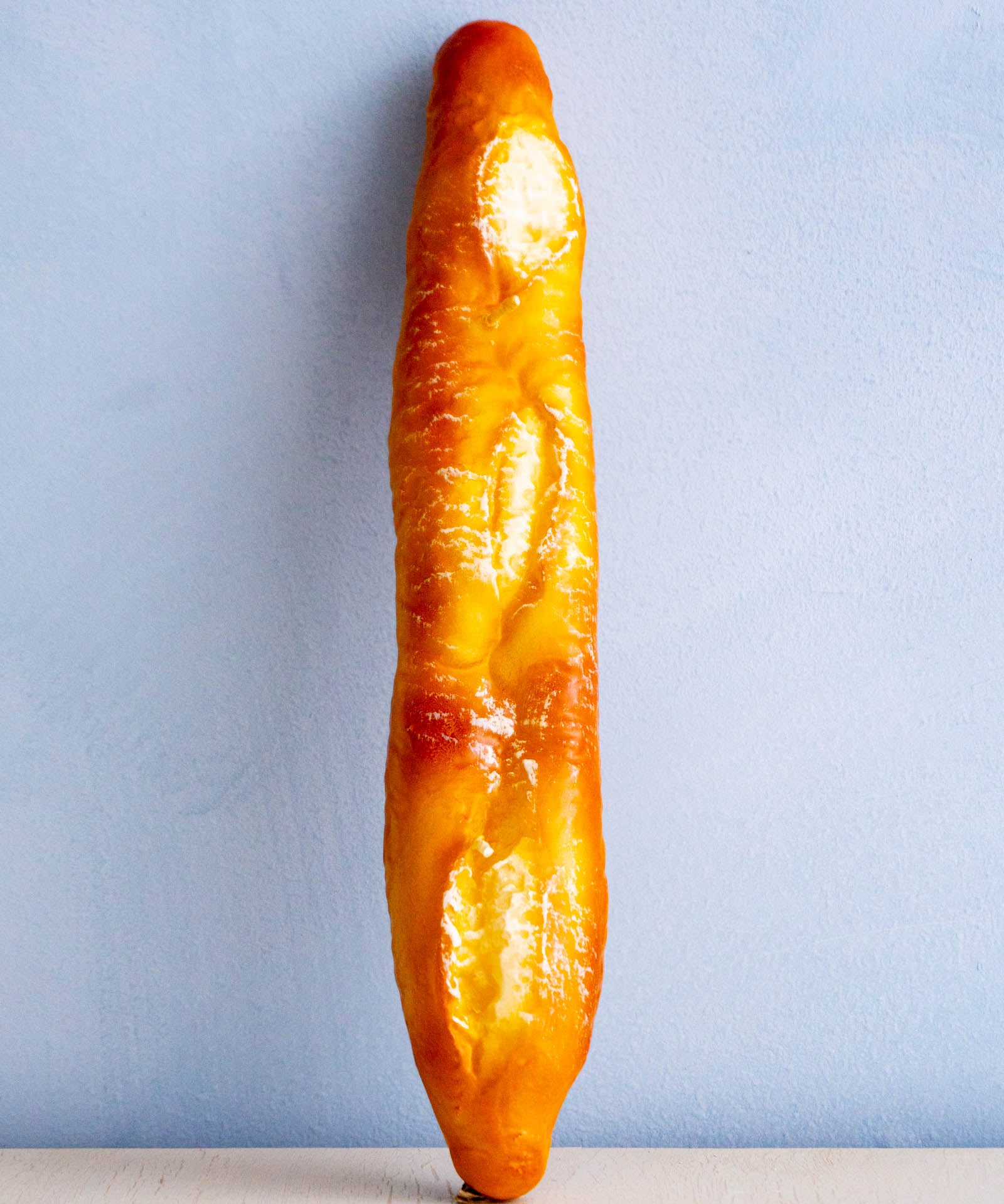 a candle shaped like a baguette 