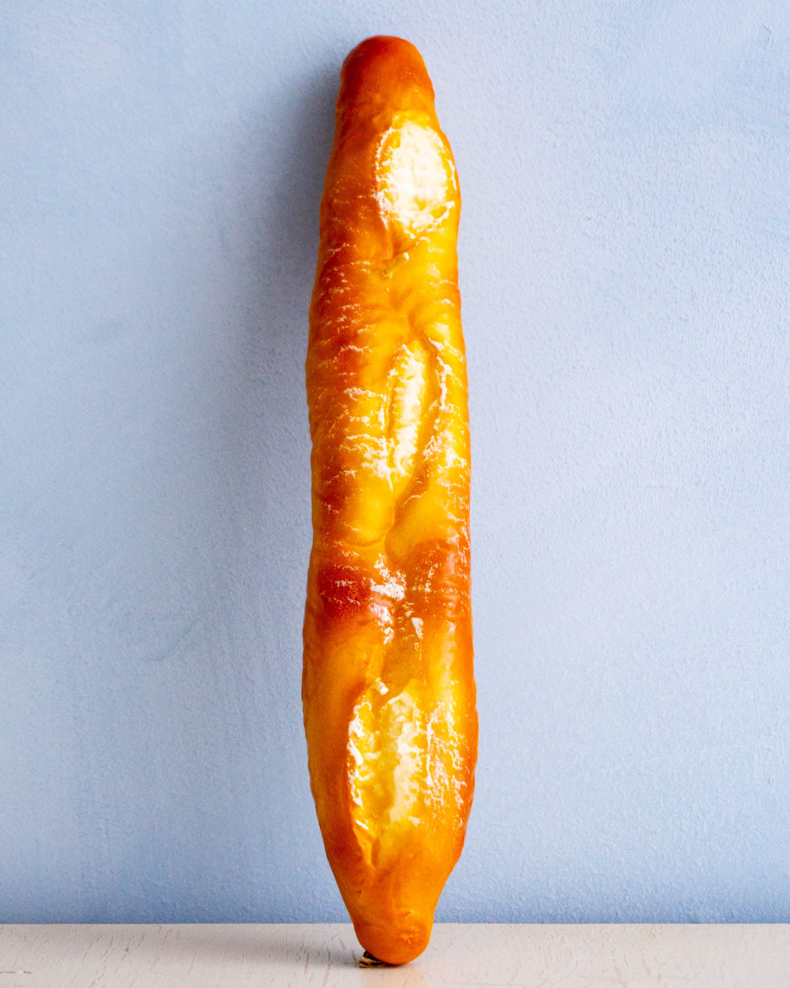 a candle shaped like a baguette 