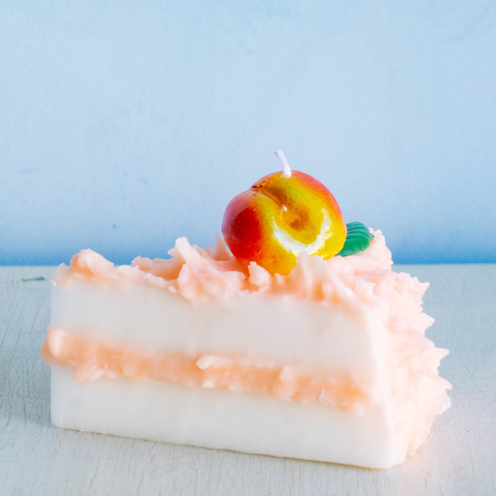 Cereria Introna candel shaped like a slice of peach cake 