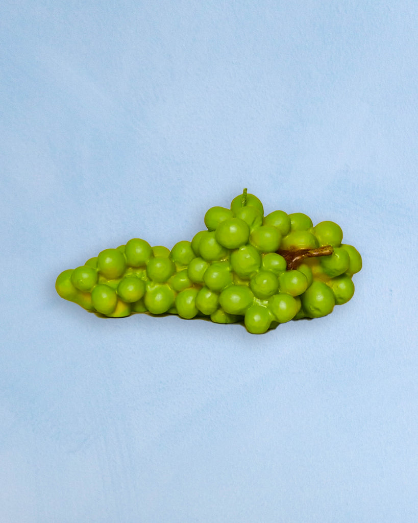 a candle shaped like a bunch of green grapes 