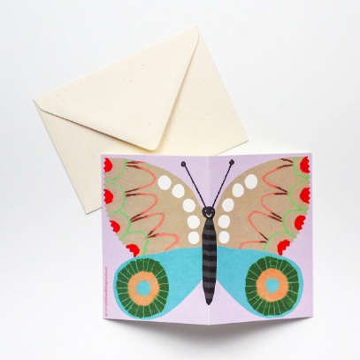 A greeting card featuring a beautiful butterfly on a lilac background. 
