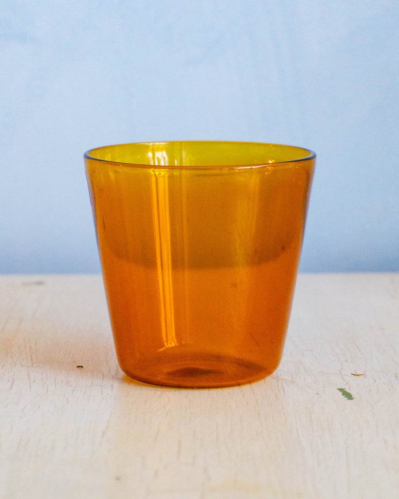 An amber coloured glass tumbler