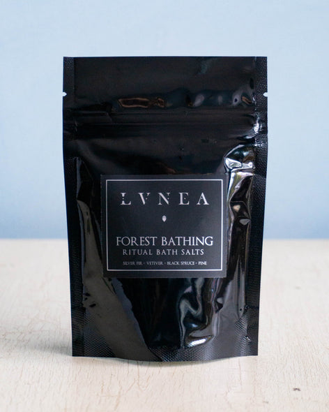 Small black bag containing sea salt bath salts and dried cedar by Lvnea.