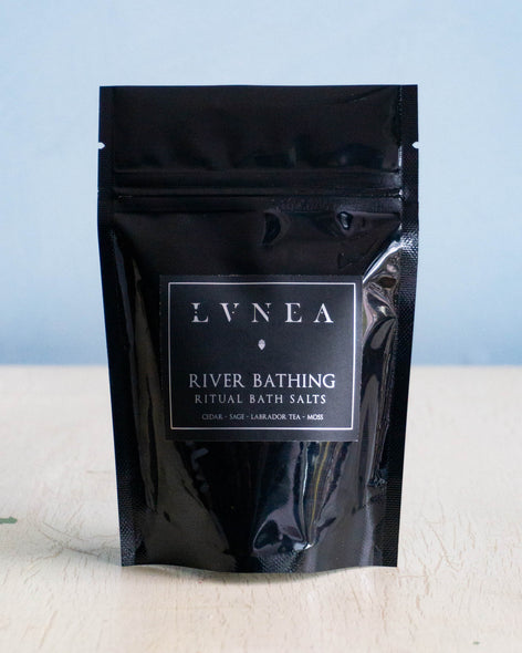 Small black bag containing sea salt bath salts by Lvnea.