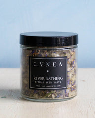 Clear glass jar filled with coarse bath salts and Labrador tea leaves by Lvnea.