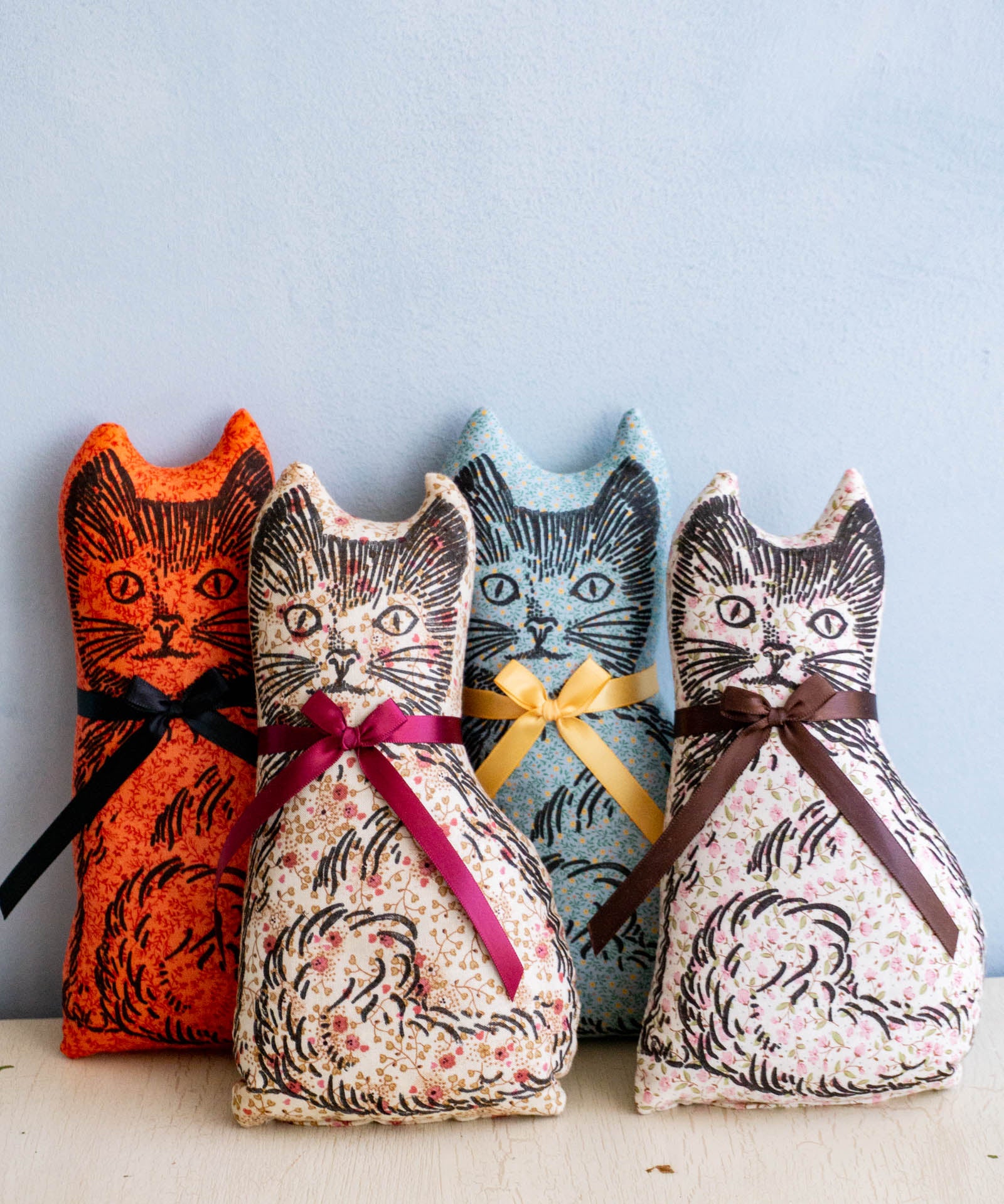 Four calico cat balsam pillows in assorted colours