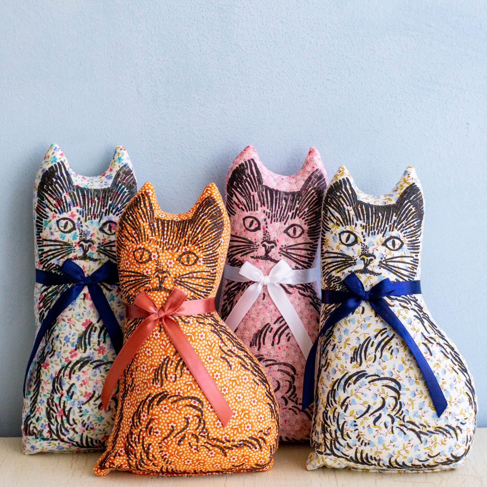 Four calico cat balsam pillows in assorted colours