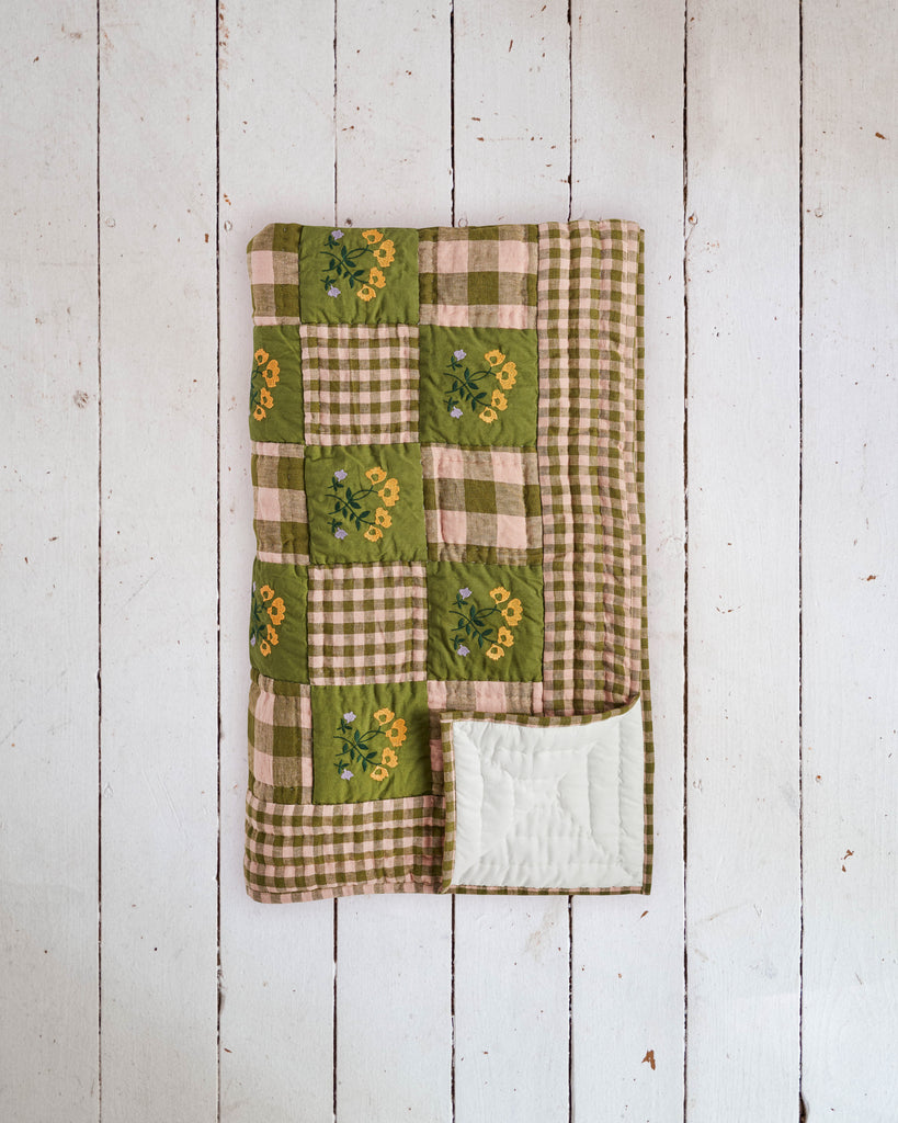 Vintage heirloom quilt, featuring alternating squares of green with yellow flowers and pink and green check.