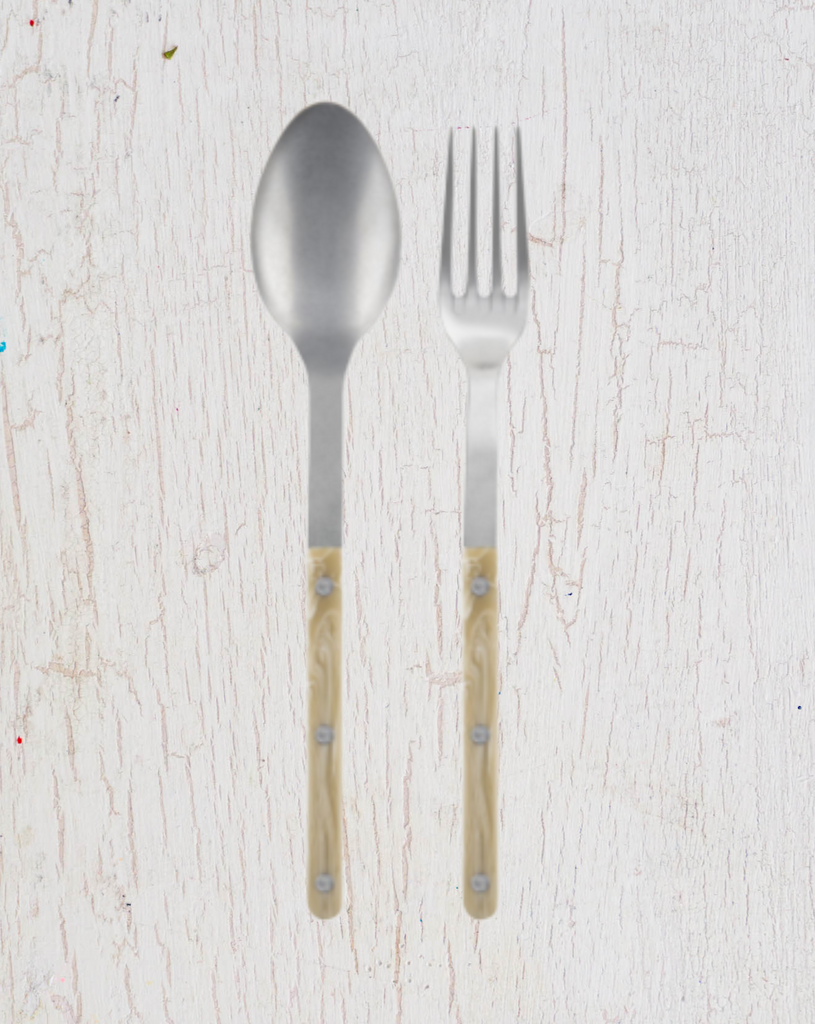 Large serving size spoon and fork, stainless steel with a cream coloured acrylic handle. By Sabre Paris.